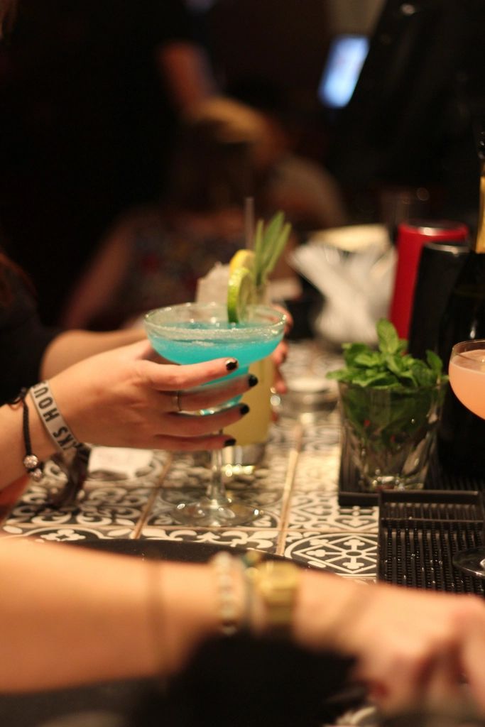 A cocktail being finished at the bar