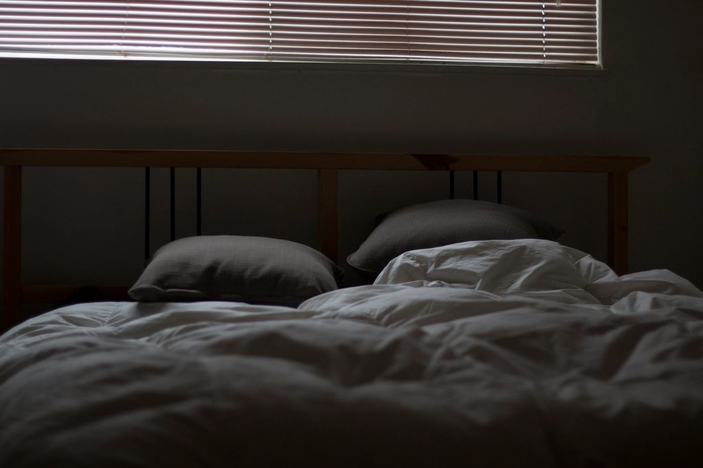 A guest room with two beds and a window